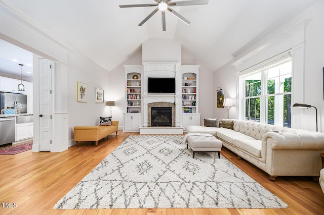 living room featuring hardwood / wood-style flooring, vaulted ceiling, and ceiling fan