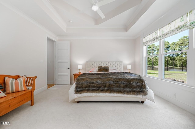 bedroom featuring crown molding, ceiling fan, a tray ceiling, and carpet floors