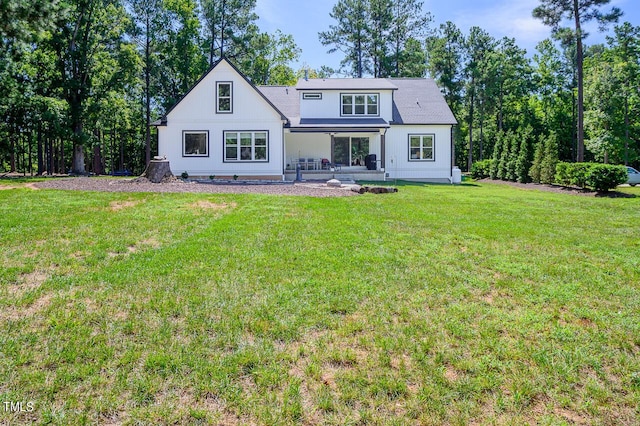 back of house featuring a yard and a patio area