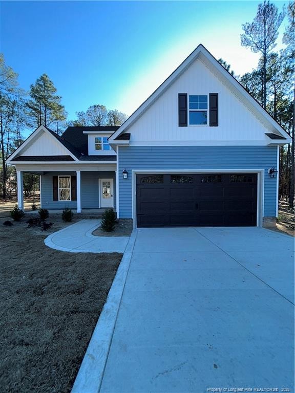 view of front of house with a porch and a garage