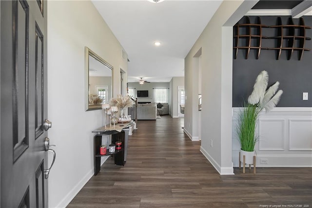 hallway with dark wood-type flooring and vaulted ceiling