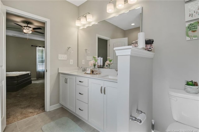 bathroom with toilet, ceiling fan, tile patterned flooring, and vanity