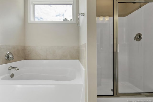 bathroom with separate shower and tub