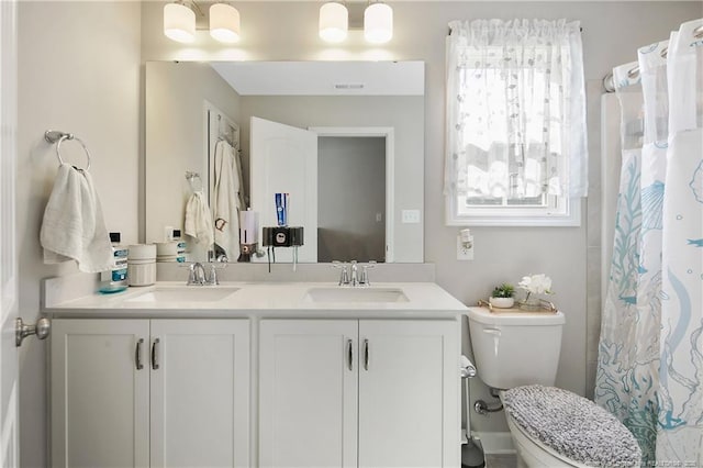 bathroom with toilet and vanity