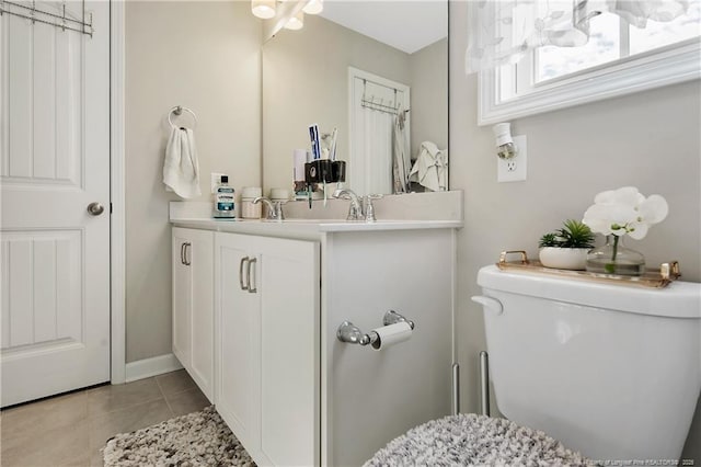 bathroom with tile patterned floors, vanity, and toilet