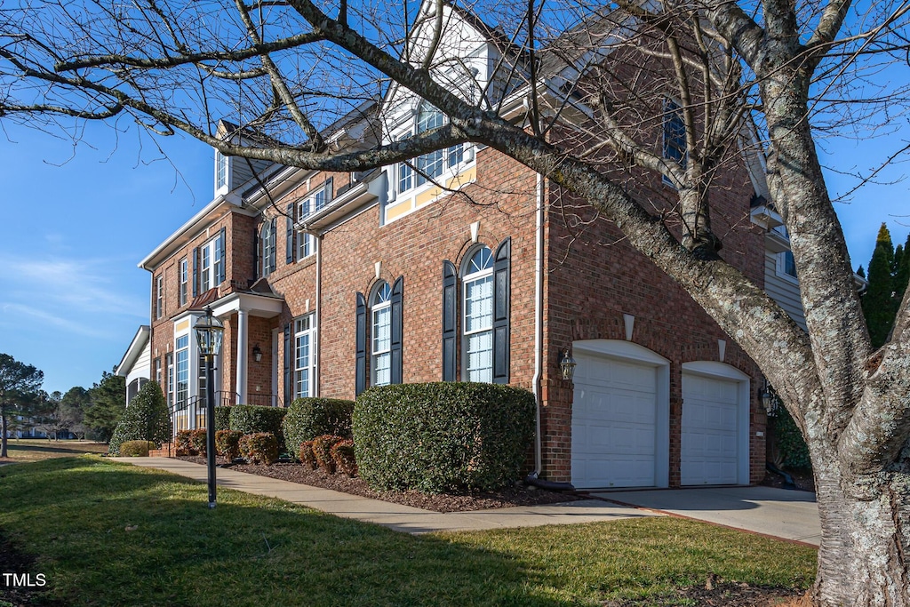 view of front of house with a garage and a front lawn