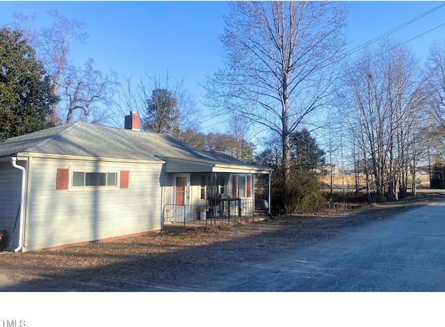 view of side of property with a porch