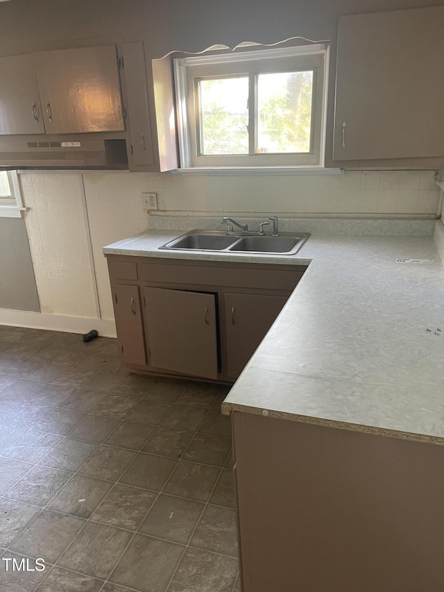 kitchen with sink and tasteful backsplash