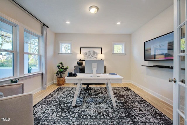 office space featuring light wood-type flooring and plenty of natural light