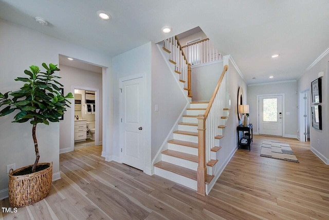 entrance foyer with light hardwood / wood-style floors and ornamental molding