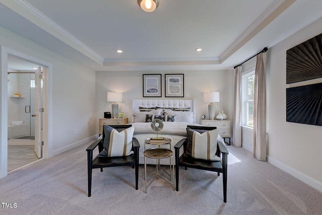 carpeted bedroom with ensuite bath, crown molding, and a raised ceiling