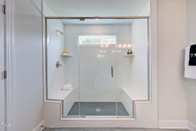 bathroom featuring a shower with shower door