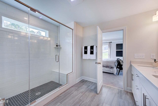 bathroom with an enclosed shower, vanity, and a wealth of natural light