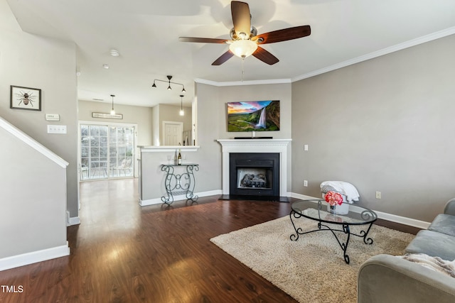 living room featuring ceiling fan, dark hardwood / wood-style floors, and crown molding