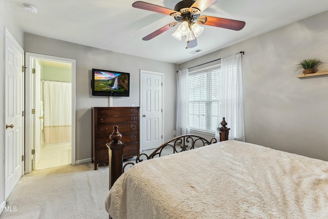 carpeted bedroom with ceiling fan and ensuite bathroom