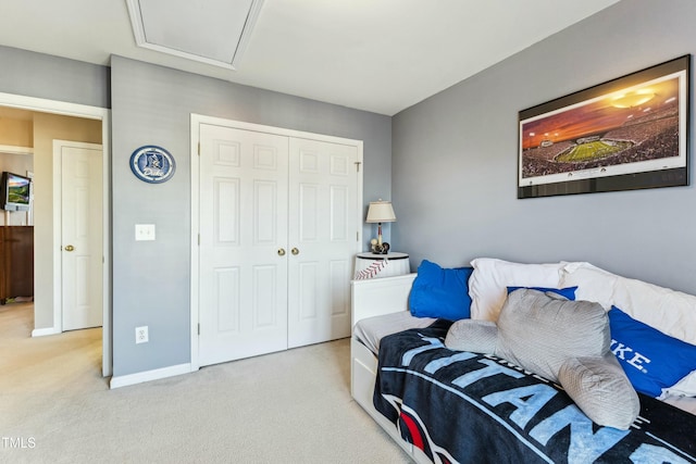 bedroom featuring light colored carpet and a closet