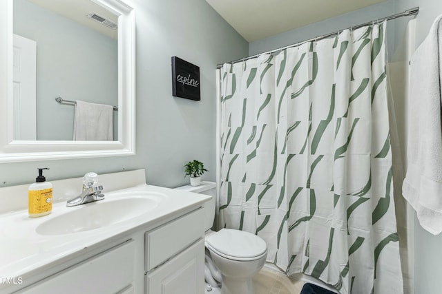 bathroom featuring toilet, vanity, and a shower with shower curtain