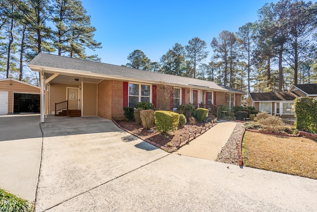 single story home with a garage and an outbuilding