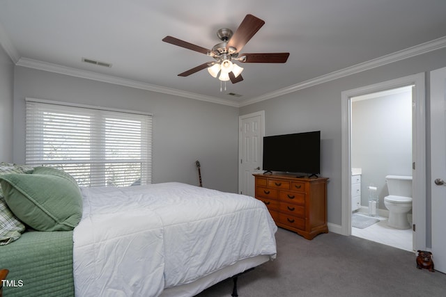 carpeted bedroom featuring ceiling fan, ensuite bathroom, and ornamental molding