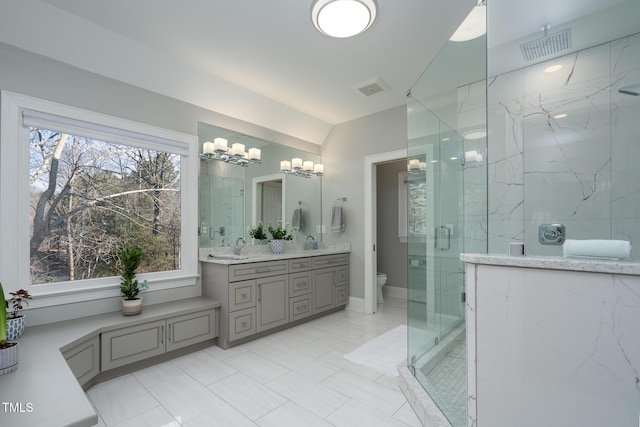 bathroom featuring toilet, walk in shower, lofted ceiling, and vanity