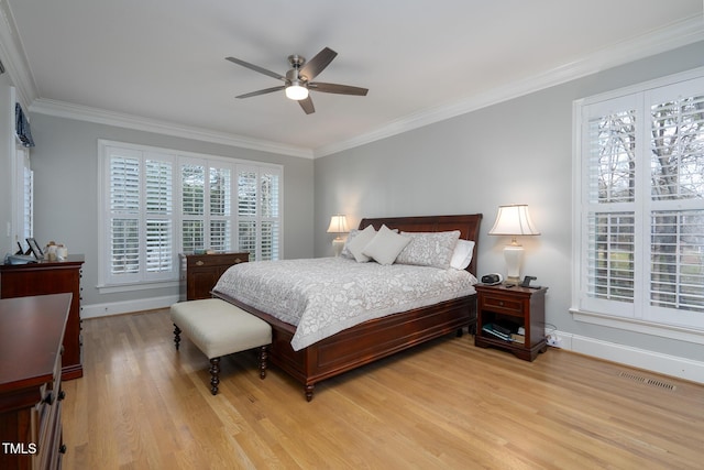 bedroom with ceiling fan, crown molding, and light hardwood / wood-style floors