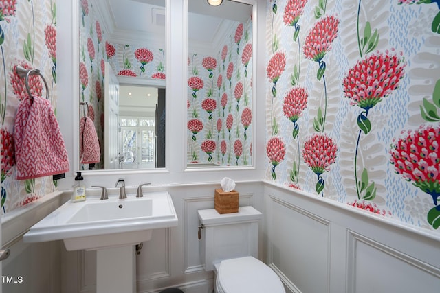 bathroom featuring toilet and ornamental molding