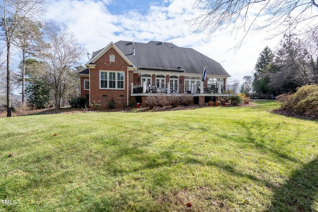 rear view of property featuring a lawn