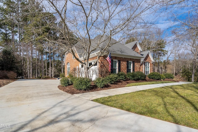 view of side of home with a yard