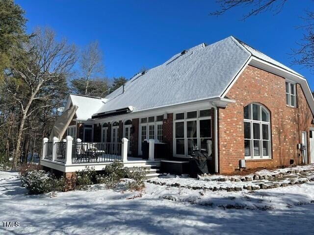 snow covered house with a porch