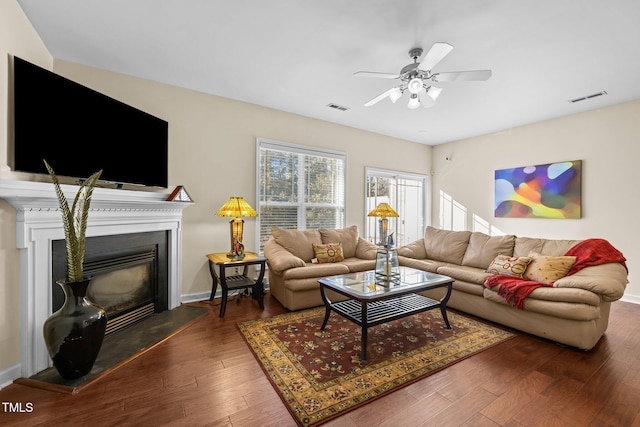 living room featuring dark wood-type flooring and ceiling fan