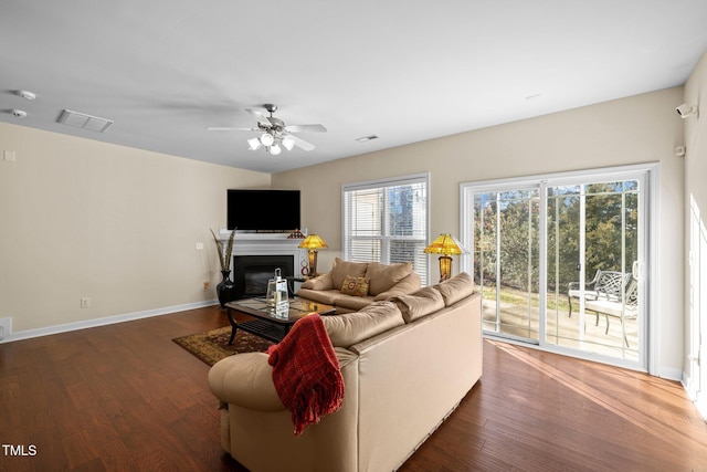 living room featuring dark hardwood / wood-style floors and ceiling fan