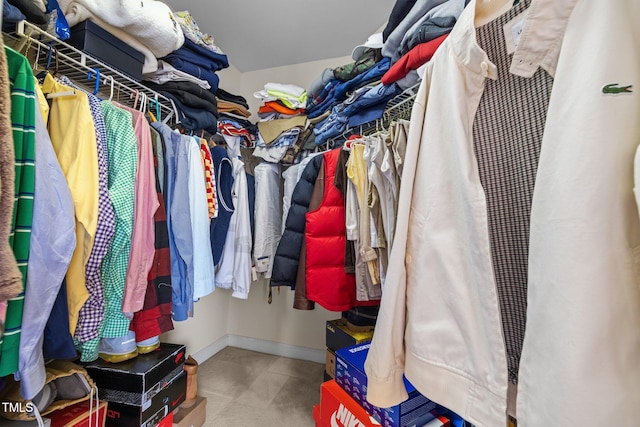 walk in closet with carpet floors