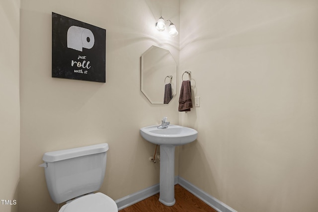 bathroom with sink, hardwood / wood-style floors, and toilet