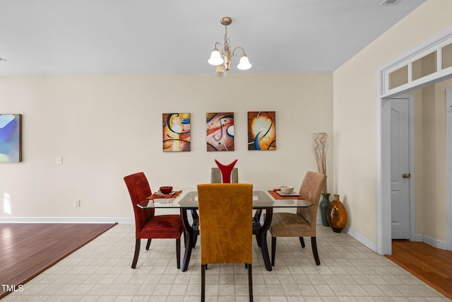 dining room featuring a chandelier and light wood-type flooring