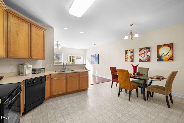 kitchen featuring a notable chandelier, sink, decorative light fixtures, and black appliances