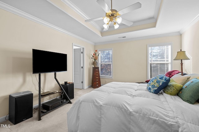 bedroom with a raised ceiling, ornamental molding, light carpet, and ceiling fan