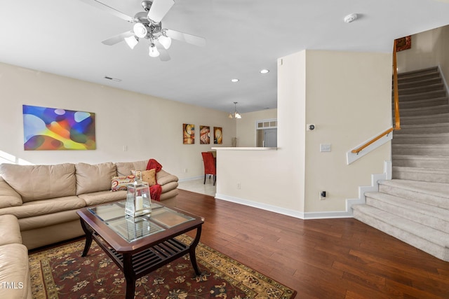 living room with wood-type flooring and ceiling fan