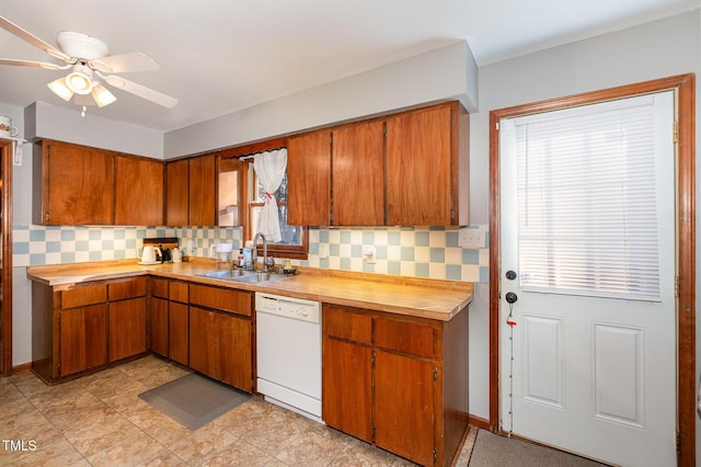 kitchen with ceiling fan, sink, backsplash, and dishwasher