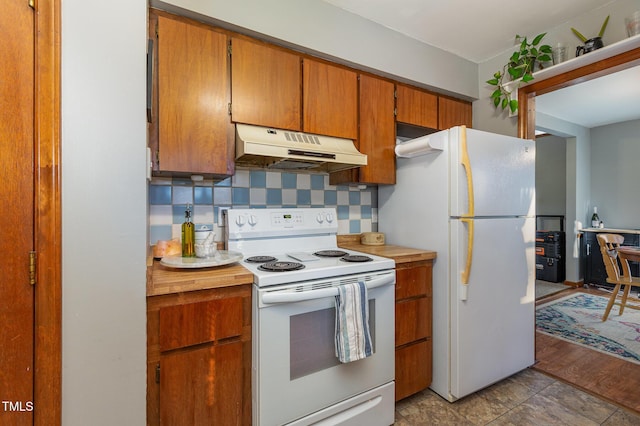 kitchen with white appliances and tasteful backsplash