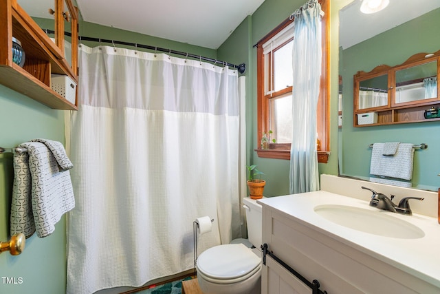 bathroom with toilet, vanity, and a shower with shower curtain