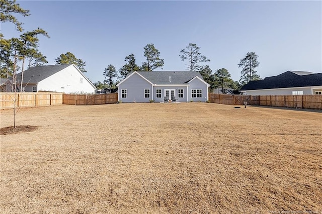 rear view of property featuring a lawn