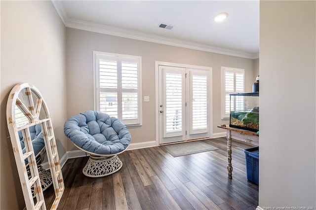 entryway with ornamental molding, dark hardwood / wood-style floors, and a wealth of natural light