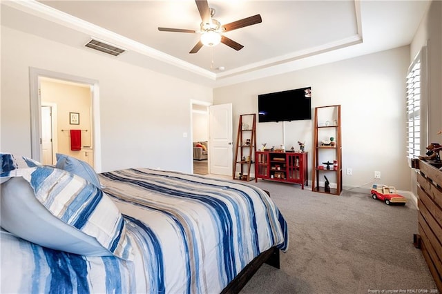 bedroom with connected bathroom, crown molding, a tray ceiling, ceiling fan, and carpet