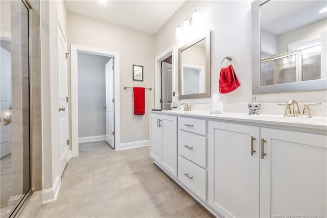 bathroom featuring vanity and a shower with shower door