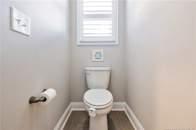 bathroom featuring hardwood / wood-style floors and toilet