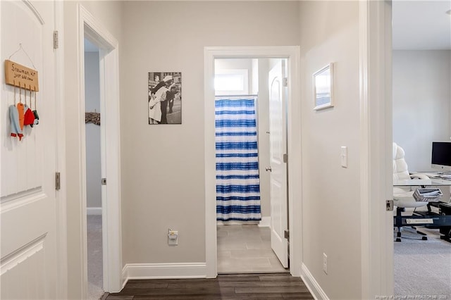 hall with dark wood-type flooring