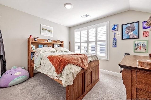 carpeted bedroom featuring lofted ceiling