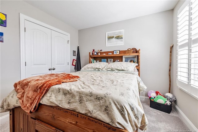 bedroom with carpet and a closet