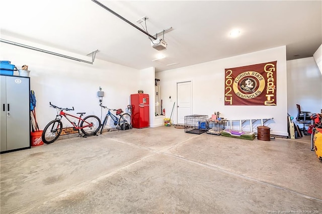 garage with a garage door opener and water heater