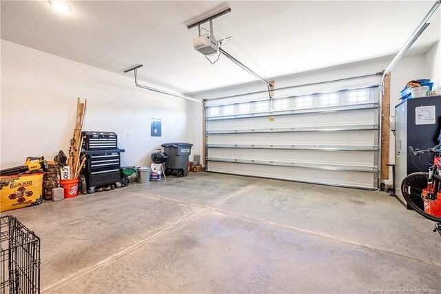 garage with a garage door opener and electric panel